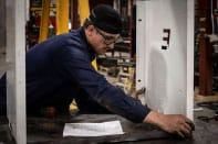 Elliott employee inspecting unit part Elliott employee inspecting unit part