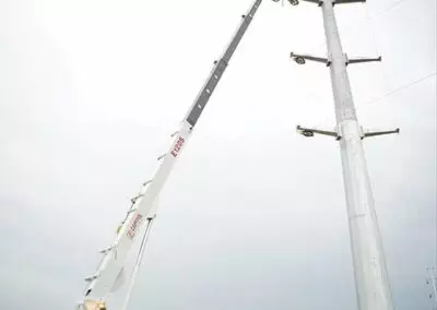 e 120 truck working on electrical tower