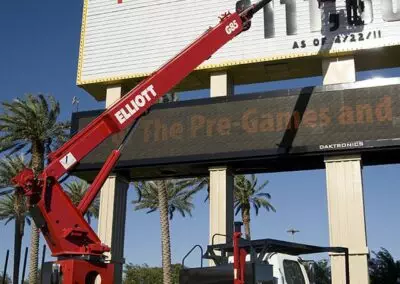 workers changing letters on marquee using a red g 85 truck