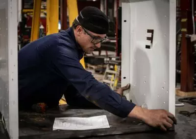 Elliott employee placing metal panel